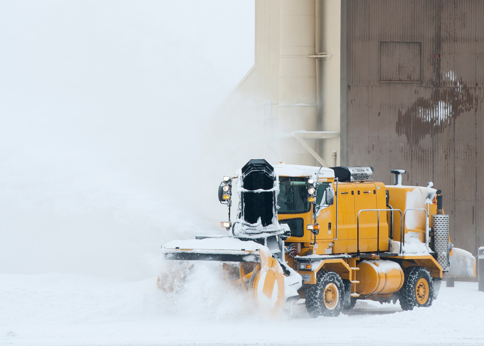 Engineering equipment operators from the 92nd Civil Engineer Squadron snow barn perform snow removal operations on the flightline during a readiness exercise at Fairchild Air Force Base, Wash., Jan. 19, 2012. (U.S. Air Force photo by Staff Sgt. Michael Means)