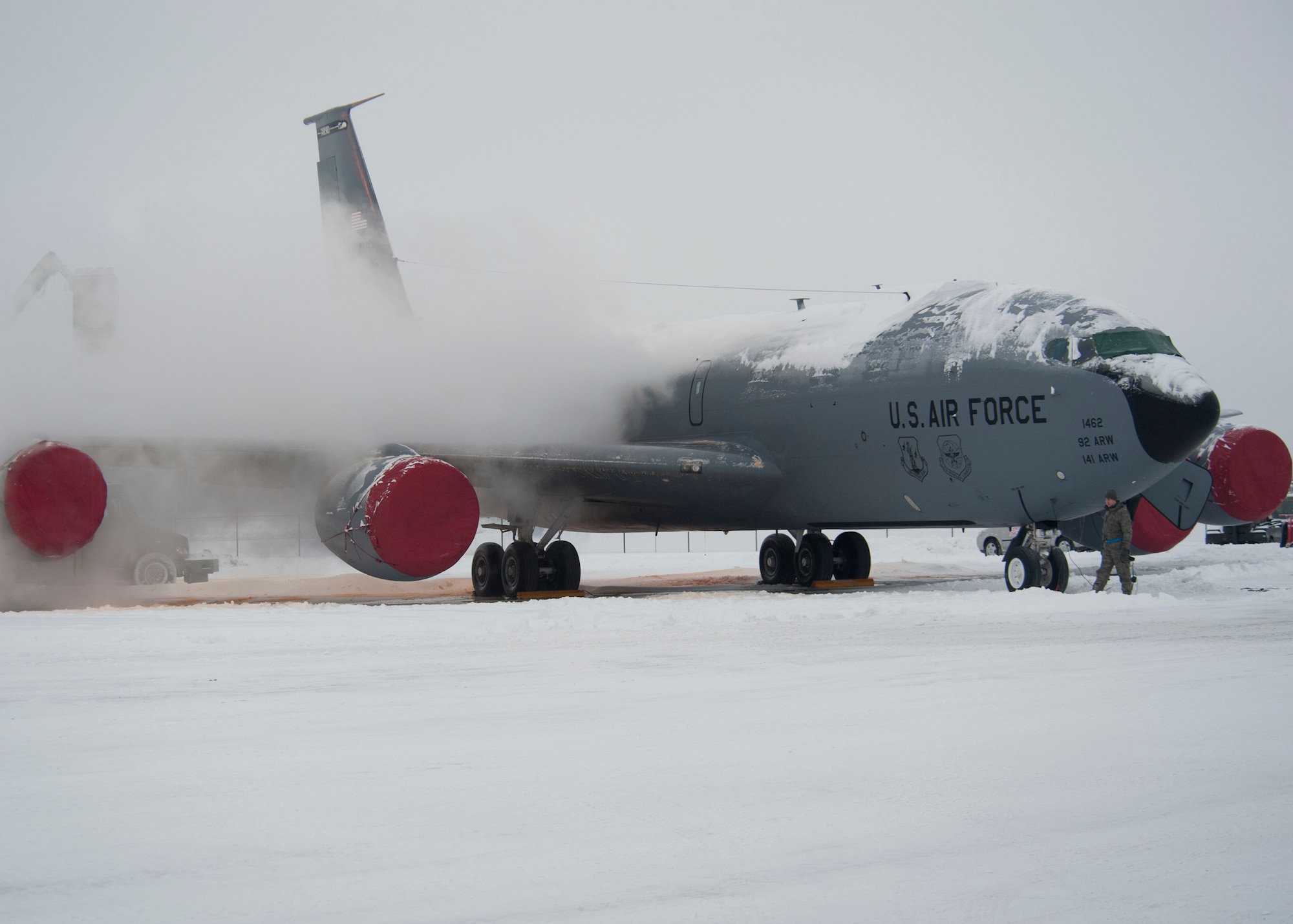 Members of the 92nd Maintenance Squadron aerospace ground equipment section de-iced a KC-135 Stratotanker refueling aircraft at Fairchild Air Force Base, Wash., Jan. 20, 2012. Maintenance Airmen removed snow from aircraft to minimize the possibility of damage prior to taxi take-off. (U.S. Air Force photo by Staff Sgt. Michael Means)