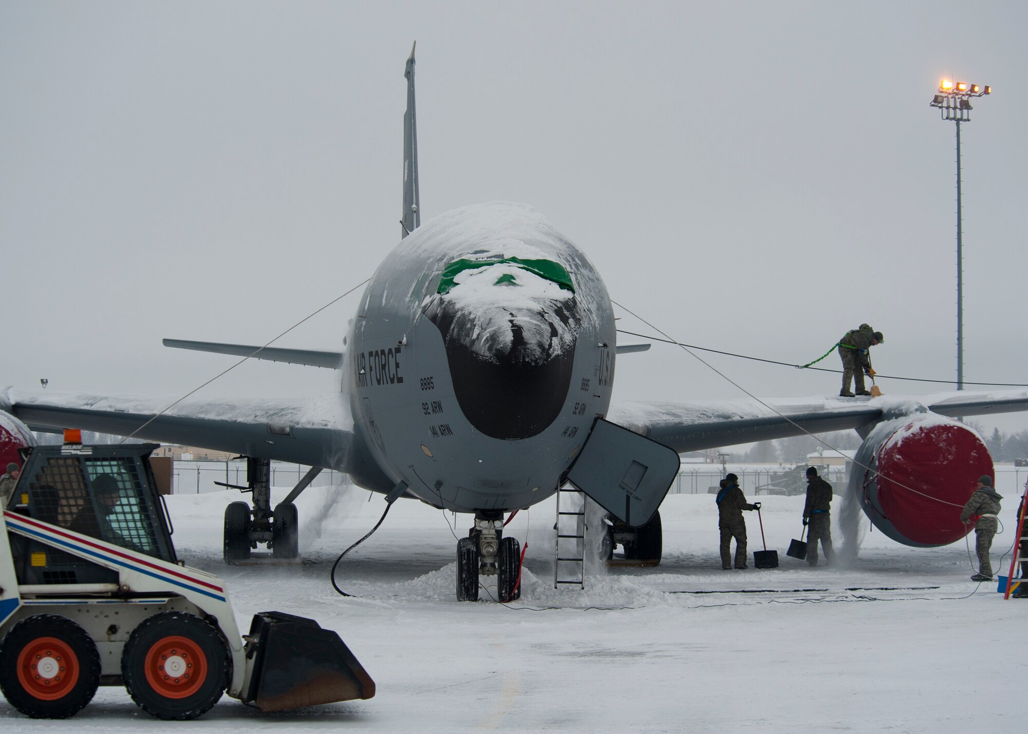 Members of the 92nd Aircraft Maintenance Squadron remove snow from a KC-135 Stratotanker refueling aircraft at Fairchild Air Force Base, Wash., Jan. 20, 2012. Maintenance Airmen removed snow from aircraft to minimize the possibility of damage prior to taxi and take-off. (U.S. Air Force photo by Staff Sgt. Michael Means)
