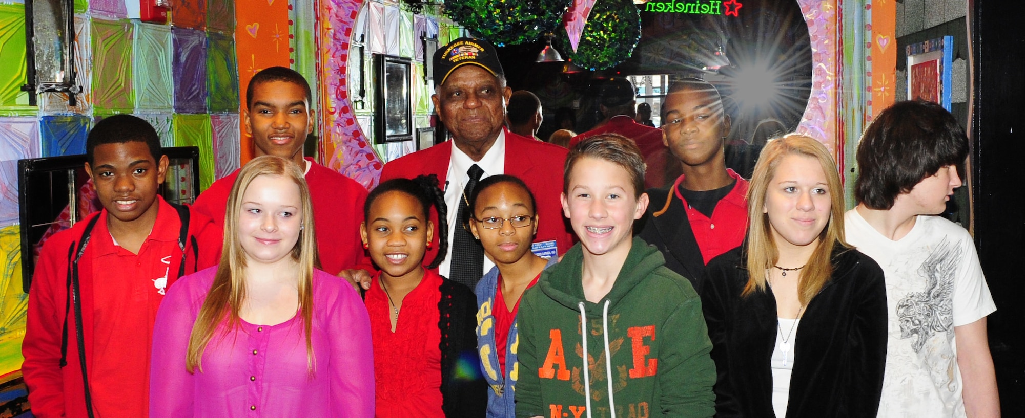 Tuskegee Airman Dr. Robert T. McDaniel, 88, poses with a group of local youths during a celebration of the opening of "Red Tails." The movie is based on the first all-black squadron of bombers, pilots and maintainers in the Armed Forces during World War II. (U.S. Air Force photo/Senior Airman Martha Whipple)