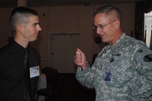 U.S. Army Maj. Gen. Richard C. Longo, senior commander Army Element Fort Eustis, chats with David Wyman, Army Family Action Plan conference delegate Jan. 20. The conference was held to help solve issues facing today’s Army families. (U.S. Army photo by Toni Guagenti/Released)