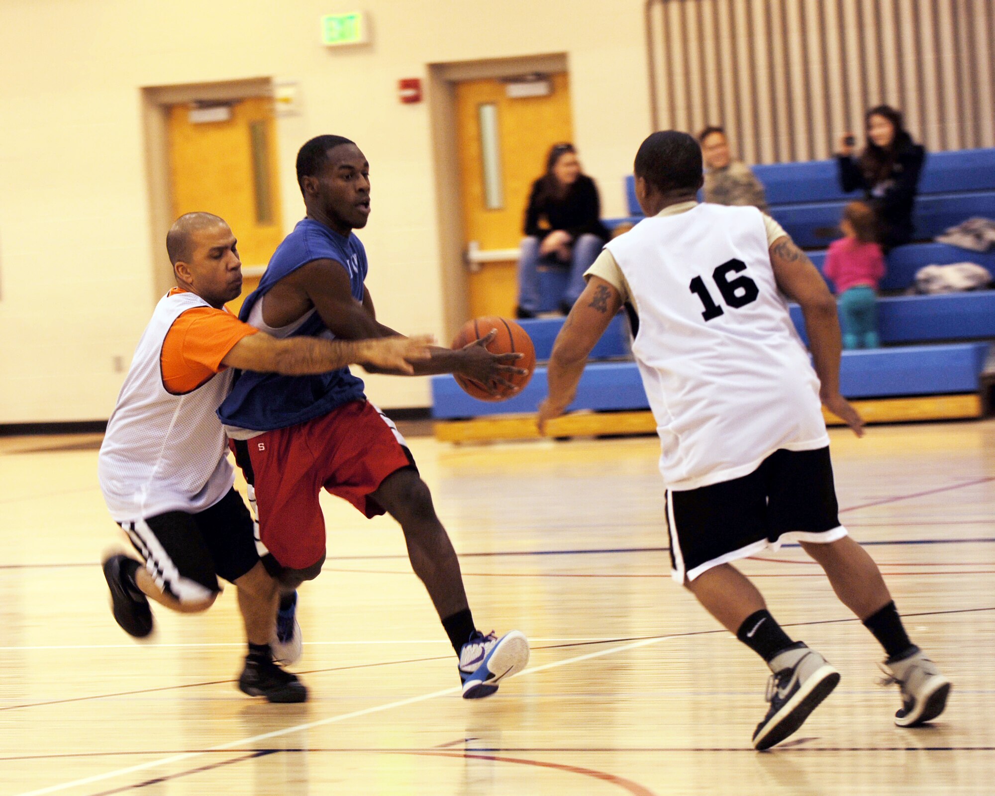 MINOT AIR FORCE BASE, N.D. -- Capt. Eddie Rubero, 5th Bomb Wing chaplain, engages opponent, Airman Raheem Ross, 5th Security Forces Squadron response force member, during an Intramural Basketball match at the McAdoo Sports and Fitness Center Jan. 24. The security forces basketball team went up against the 5th BW nightmares and won a narrow victory of 54 to 52 points. Intramural leagues such as these support unit cohesiveness, all while promoting fitness. (U.S. Air Force photo/Senior Airman Jose L. Hernandez)