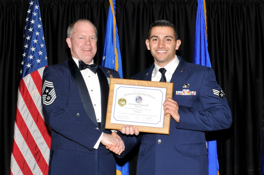 McGHEE TYSON AIR NATIONAL GUARD BASE, Tenn. - Senior Airman John R. Vasta III, right, receives the distinguished graduate award for Airman Leadership School Class 12-1, at The I.G. Brown Air National Guard Training and Education Center from the Air National Guard Command Chief Master Sgt. Christopher E. Muncy, Dec. 13, 2011.  The distinguished graduate award is presented to students in the top ten percent of the class.  It is based on objective and performance evaluations, demonstrated leadership, and performance as a team player. (U.S. Air Force photo by Master Sgt. Kurt Skoglund/Released)