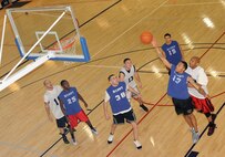 MINOT AIR FORCE BASE, N.D. -- Airman Everett J. McCarley, 5th Security Forces Squadron response force member, jumps up for a rebound during an Intramural Basketball match at the McAdoo Sports and Fitness Center Jan. 24. The security forces basketball team went up against the 5th Bomb Wing nightmares and won a narrow victory of 54 to 52 points. Intramural leagues such as these support unit cohesiveness, all while promoting fitness. (U.S. Air Force photo/Senior Airman Jose L. Hernandez)
