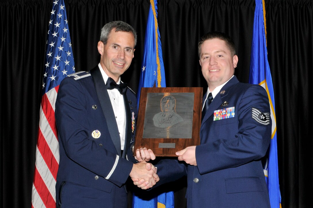 McGHEE TYSON AIR NATIONAL GUARD BASE, Tenn. - Tech. Sgt. Clayton Brown, right, receives the John L. Levitow honor award for Satellite NCO Academy Class 12-1 at The I. G. Brown Air National Guard Training and Education Center from Col. Tim Cathcart, commander, Dec. 13, 2011. The John L. Levitow award is the highest honor awarded a graduate of any Air Force enlisted professional military education course. (U.S. Air Force photo by Master Sgt. Kurt Skoglund/Released)
