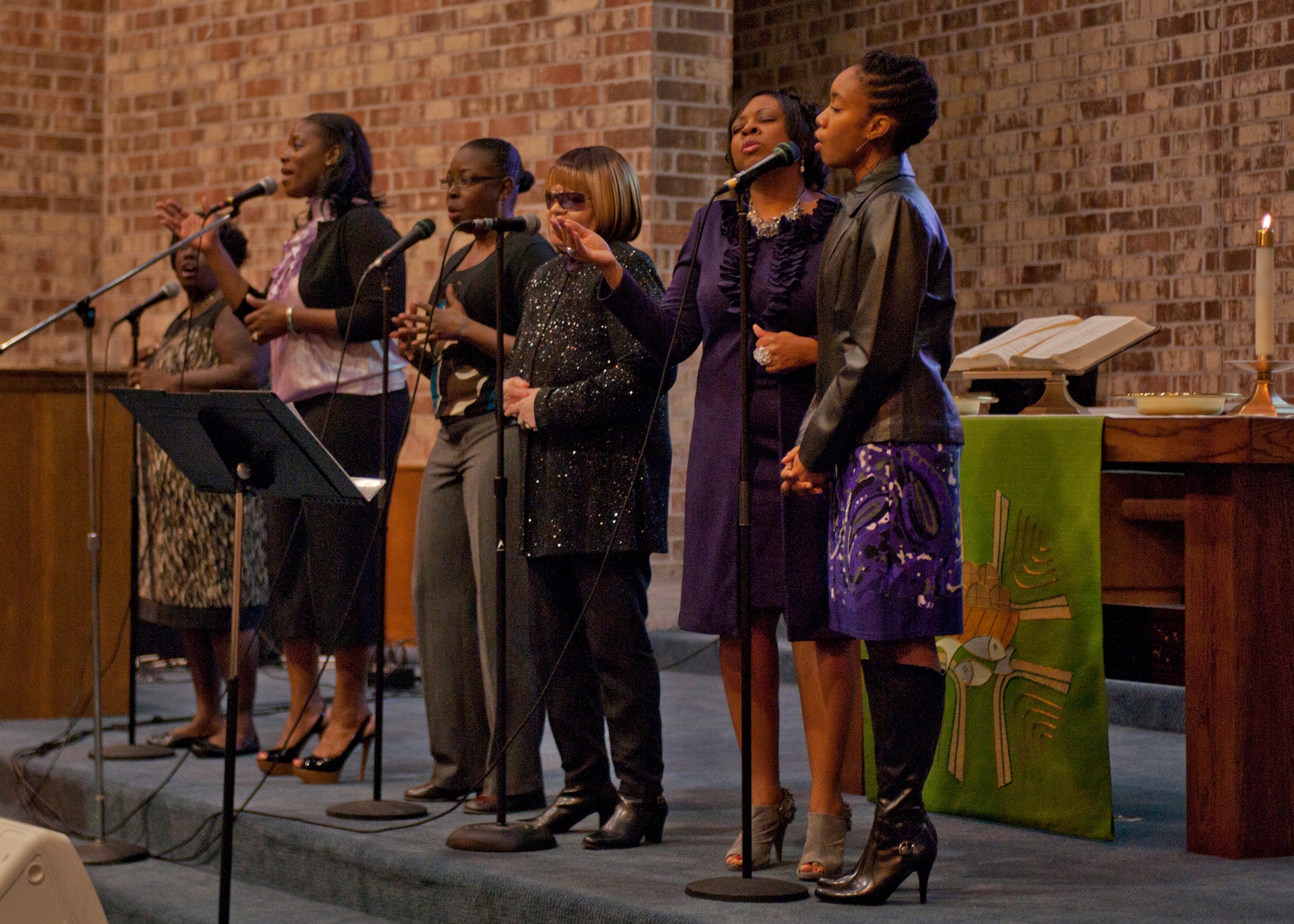 The Moody Air Force Base Gospel Praise Team sings during a Sunday morning Gospel service featuring U.S. Air Force Col. Gregory Tate, Air Combat Command chaplain, Jan. 22, 2012. Among the GPT are two active duty Airmen who got the opportunity to sing for Tate who later preached during the service. (U.S. Air Force photo by Senior Airman Eileen Meier/Released) 