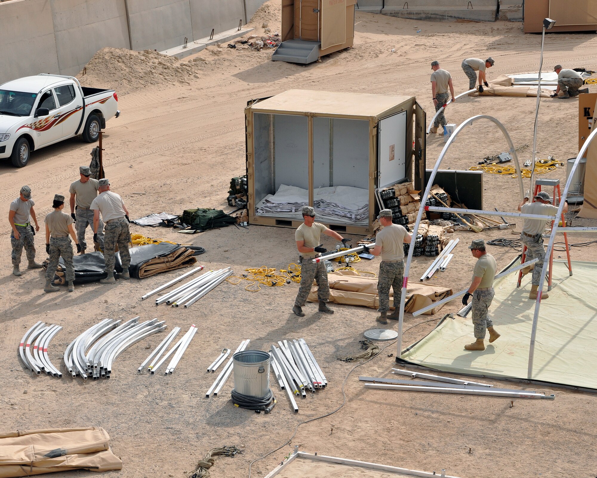 Airmen with the 386th Air Expeditionary Wing meticulously sort one of 125 Alaskan tents for storage Jan. 25, 2012, after the end of Operation New Dawn in Iraq and reduction in forces at an undisclosed location in Southwest Asia.  Each tent must be folded and packed following specific guidelines to ensure all materials, from the outside fabric to the inner framework, lighting and miscellaneous pieces, fit properly into containers for storage.  The collection of tents housed large numbers of transitioning troops out of the area of responsibility, and all will be taken down and stored until needed again. (U.S. Air Force photo/Tech. Sgt. Stacy Fowler)