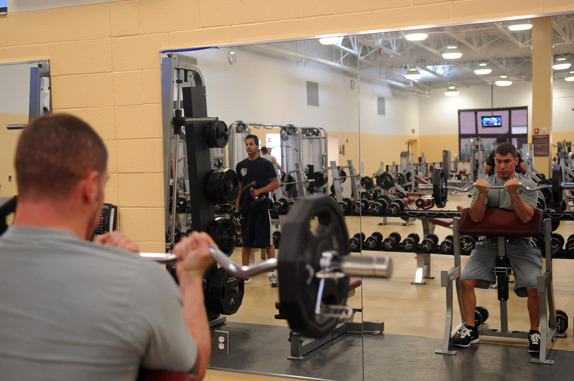 U.S. Air Force Tech. Sgt. Andrew Dicarlo, 20th Operations Support Squadron air traffic controller watch supervisor/RAPCON, begins his work out with free weights at the fitness center, Shaw Air Force Base, S.C., Jan. 24, 2012. Shaw Airmen use the fitness center daily to keep up their physical fitness ensuring they are prepared for deployment. (U.S. Air Force photo by Airman First Class Hunter Brady/Released)