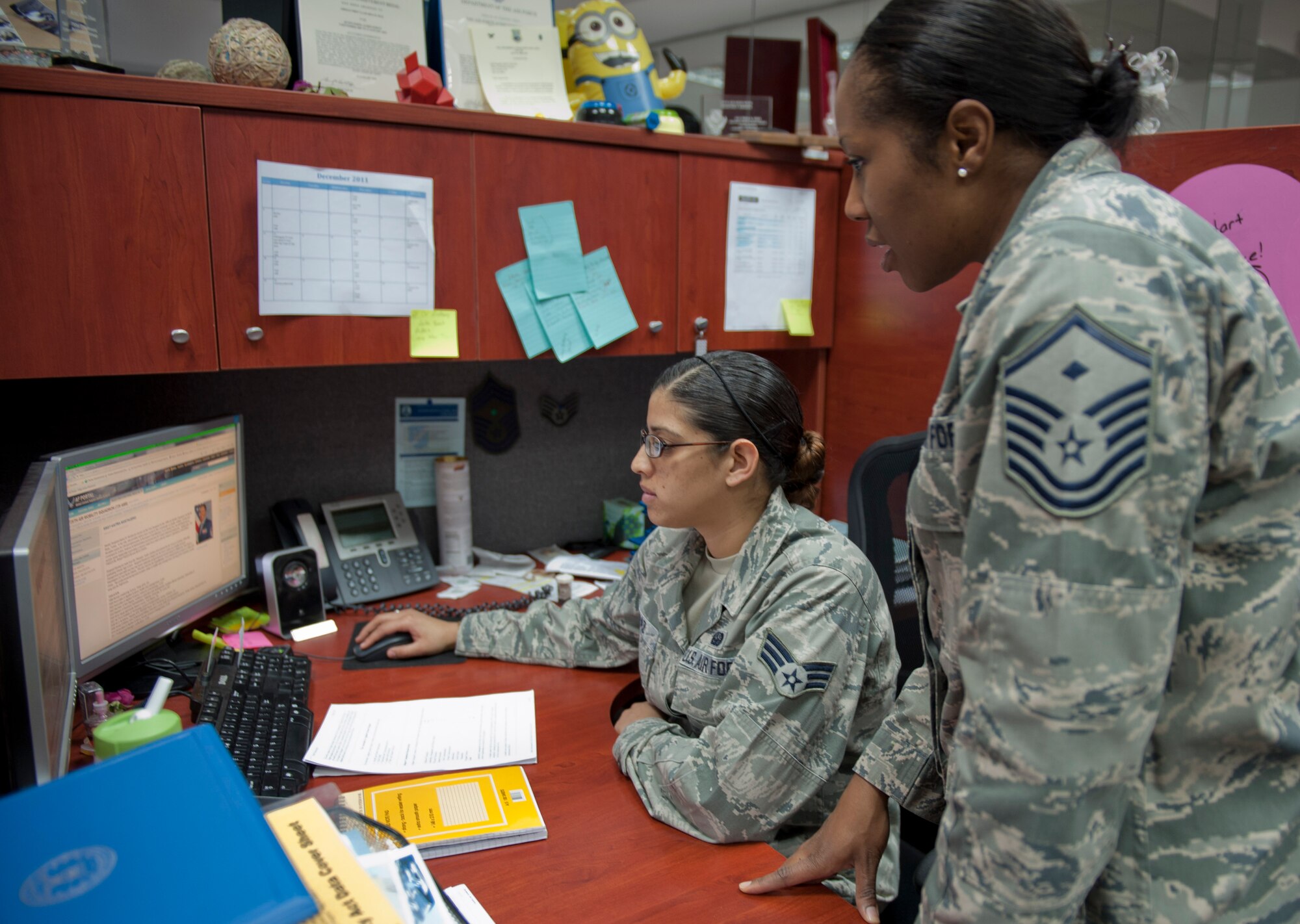 Master Sgt. Anitra Mostacero, 728th Air Mobility Squadron first sergeant, right, and Senior Airman Irna Diaz, 728th AMS knowledge operations manager, review Mostacero's official biography online Dec. 16, 2011, at Incirlik Air Base, Turkey. This is Mostacero's seventh squadron as a first sergeant. (U.S. Air Force photo by Senior Airman Anthony Sanchelli/Released)
