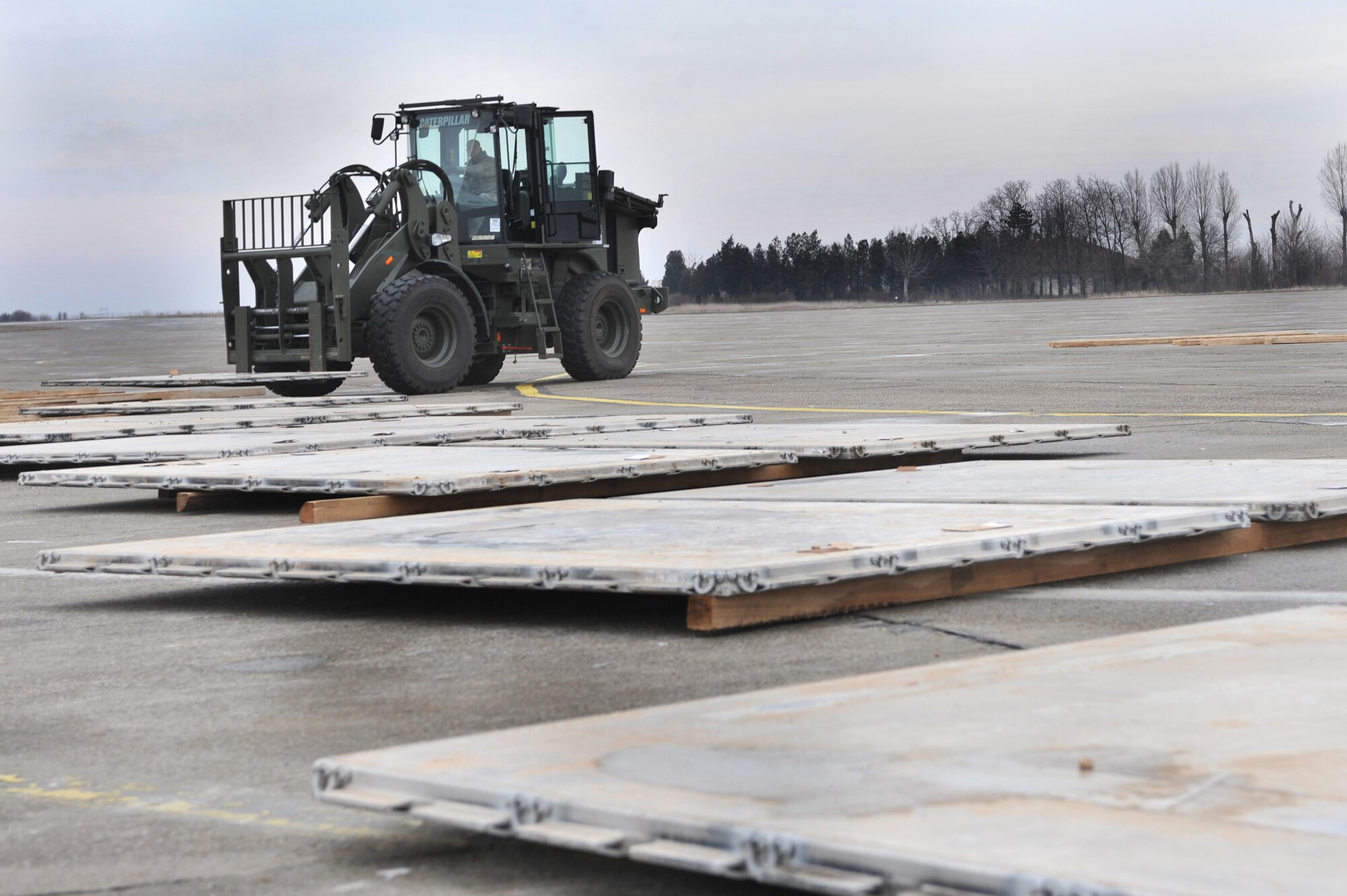 A member of the 435th Contigency Response Group drives a fork lift to stack pallets while on location in Constanta, Romania, Jan. 19, 2012. The 435th CRG unloaded more then 100 pallets worth of equipment during their temparary duty assignment.(U.S. Air Force photo by Airman 1st Class Caitlin O'Neil-McKeown)