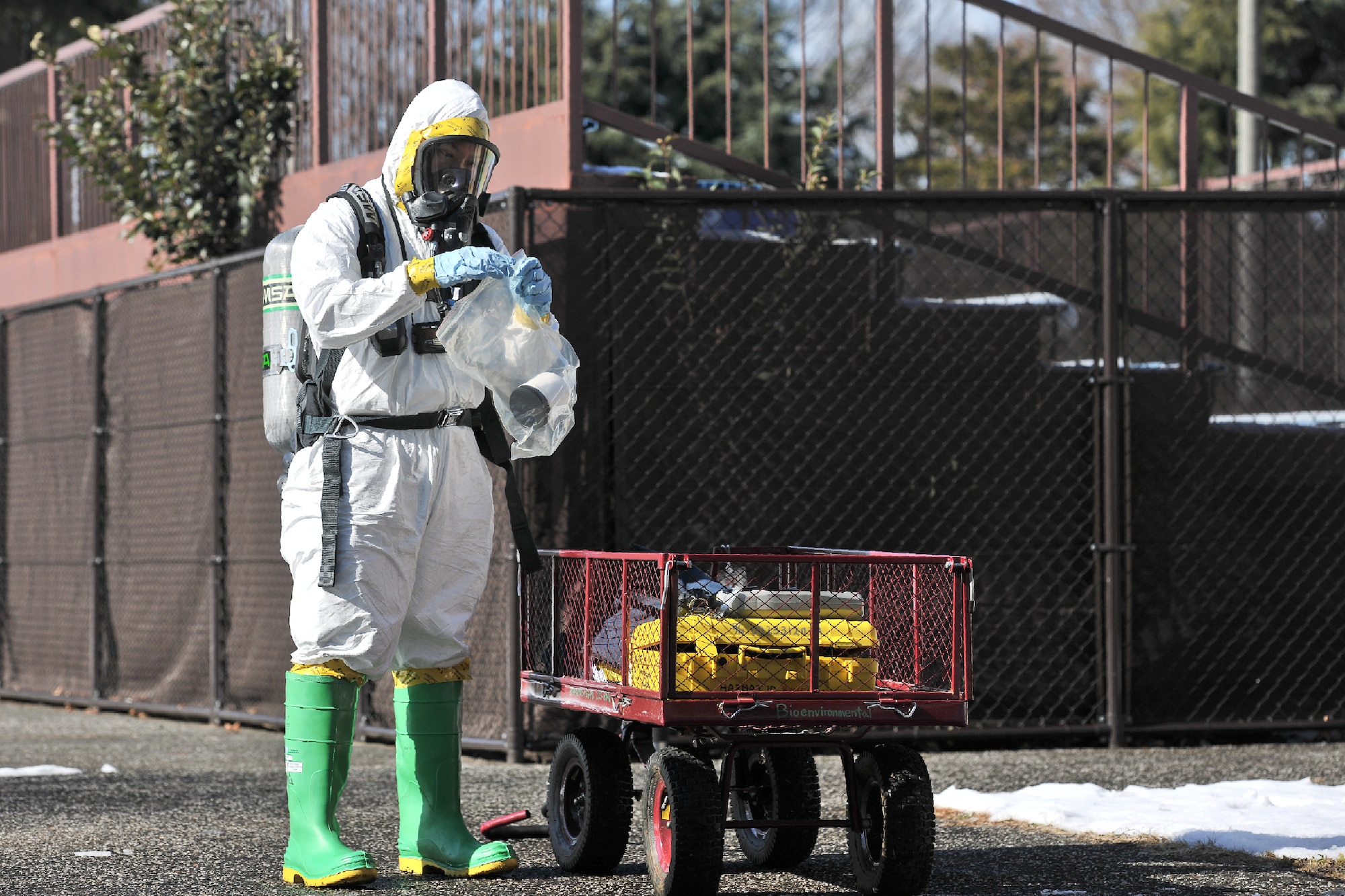 YOKOTA AIR BASE, Japan -- Staff Sgt. Micheal Ona, 374th Aerospace Medicine Squadron bioenvironmental engineer technician, takes a sample of simulated unknown substances during an emergency management exercise at Yokota Air Base, Japan, Jan. 25, 2012. Yokota airmen use exercises to maintain operational readiness capabilities. (U.S. Air Force photo/Osakabe Yasuo)