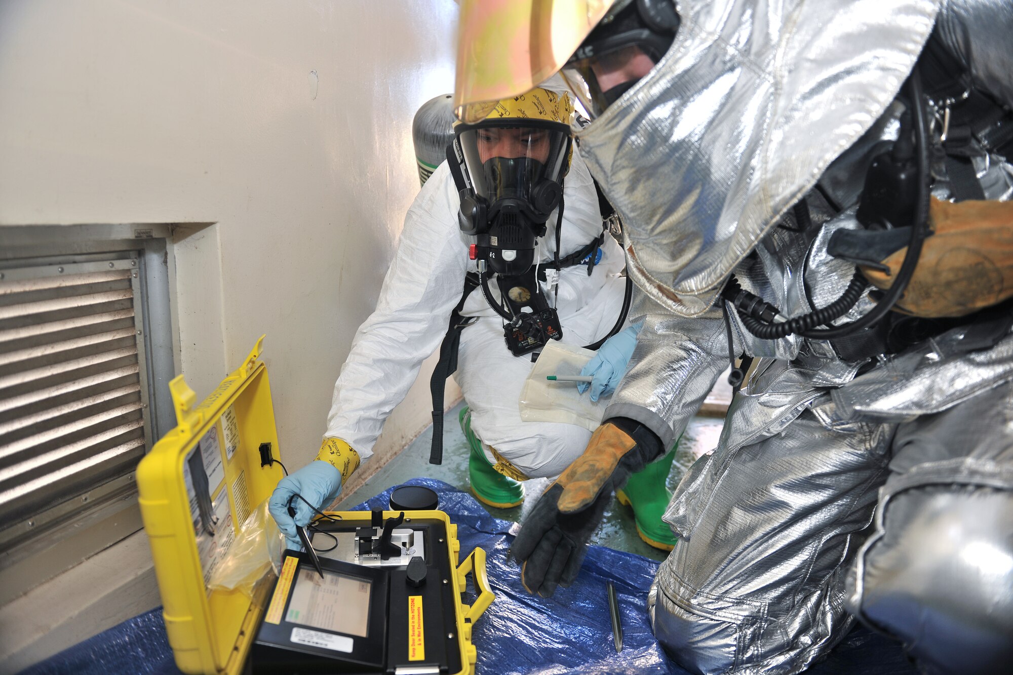 OKOTA AIR BASE, Japan -- (Left to right) Staff Sgt. Micheal Ona, 374th Aerospace Medicine Squadron bioenvironmental engineer technician, and Staff Sgt. Ian Coye, 374th Civil Engineer Squadron fire emergency services crew chief, conduct a field test on a simulated unknown substances using a HAZMAT ID portable laboratory during an emergency management exercise at Yokota Air Base, Japan, Jan. 25, 2012. Yokota airmen use exercises to maintain operational readiness capabilities. (U.S. Air Force photo/Osakabe Yasuo)