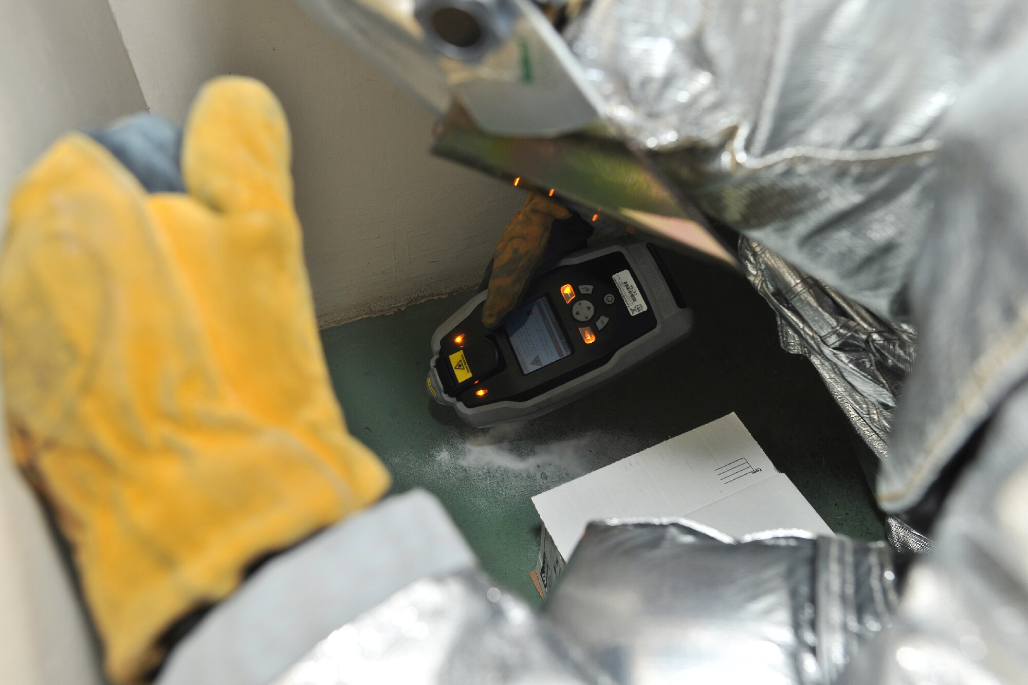 YOKOTA AIR BASE, Japan -- Staff Sgt. Ian Coye, 374th Civil Engineer Squadron fire emergency services crew chief, investigates simulated unknown substances during an emergency management exercise at Yokota Air Base, Japan, Jan. 25, 2012. Yokota airmen use exercises to maintain operational readiness capabilities.  (U.S. Air Force photo/Osakabe Yasuo)