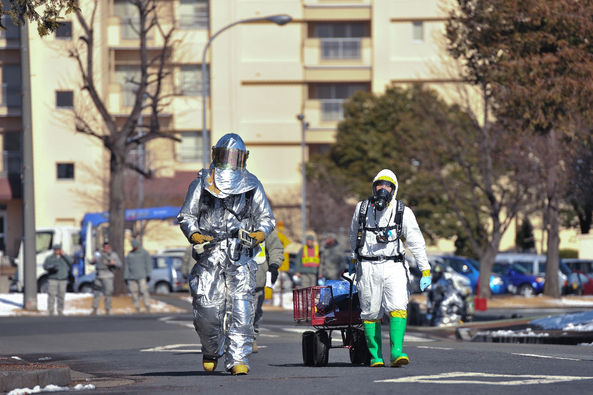 YOKOTA AIR BASE, Japan -- (Left to right) Staff Sgt. Ian Coye, 374th Civil Engineer Squadron fire emergency services crew chief, and Staff Sgt. Michael Ona, 374th Aerospace Medicine Squadron bioenvironmental engineering technician, respond in the investigation of a simulated unknown substances during an emergency management exercise at Yokota Air Base, Japan, Jan. 25, 2012. Yokota airmen use exercises to maintain operational readiness capabilities.  (U.S. Air Force photo/Osakabe Yasuo)