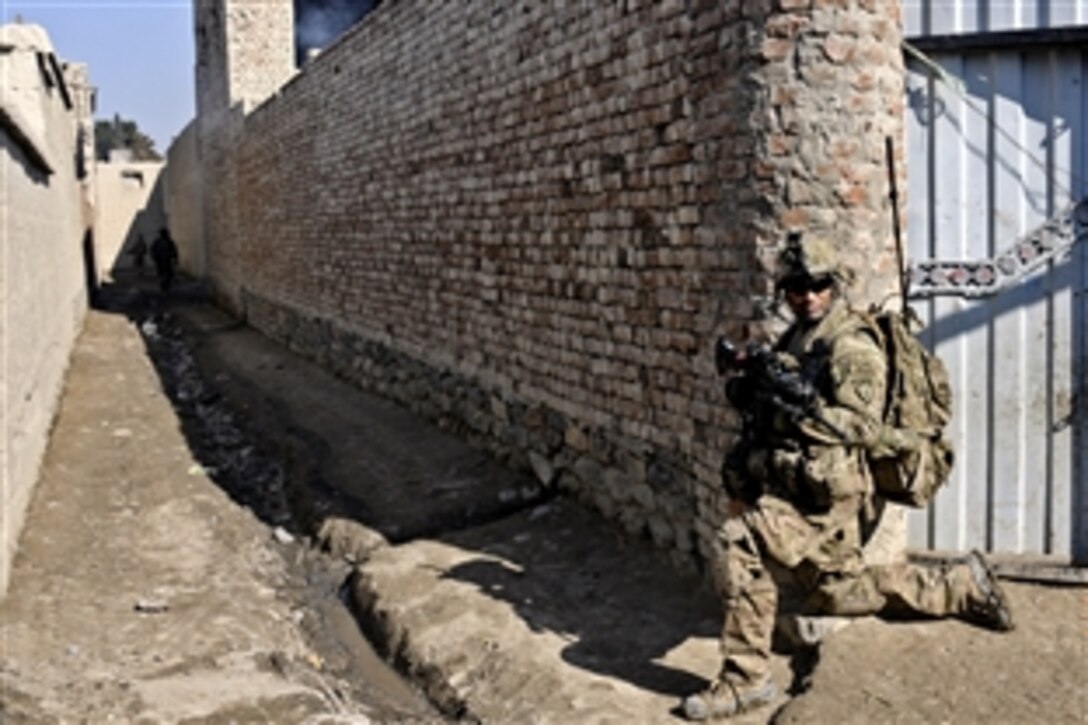 U.S. Army Sgt. Ramon Cortez takes a knee while providing security detail during a combat patrol in Khowst province, Afghanistan, Jan. 25, 2012. Cortez is assigned to 2nd Battalion, 377th Parachute Field Artillery Regiment, Task Force Spartan Steel. 