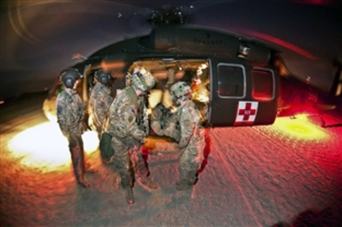 Army medics unload a mock casualty from a UH-60 Black Hawk medevac helicopter during a training exercise at the Joint Readiness Training Center on Fort Polk, La., Jan. 23, 2012.