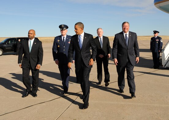 BUCKLEY AIR FORCE BASE, Colo. -- President Barack Obama, followed by Michael Hancock, mayor of Denver, Col. Daniel Dant, 460th Space Wing commander, Ray Mabus, Secretary of the Navy and Michael B. Donley, Secretary of the Air Force, proceeds to one of Buckley Air Force Base's hangers Jan. 26, 2012. The president arrived at Buckley for a press conference on clean energy programs. (U.S. Air Force photo by Senior Airman Marcy Glass)