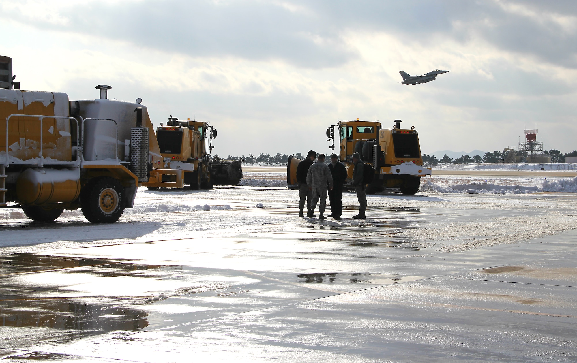 A winter storm swept across the Kunsan Air Base, Republic of Korea, region Jan. 24 and 25, 2012, bringing more than three inches of snow and sub-freezing temperatures to the base and surrounding communities. Following the storm, crews from the 8th Civil Engineer Squadron worked quickly to remove snow from the flightline and around base in an effort to allow the Wolf Pack’s flying schedule to return to normal operations. (Courtesy photo)