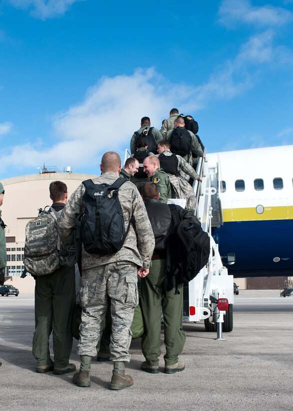 Ellsworth Airmen board a plane destined for Nellis Air Force Base, Nev. for the Red Flag training exercise Jan. 20, 2012. The exercise uses real-world scenarios and tactics along with live munitions for bombing runs on the Nevada Test and Training Range to mimic combat situations. (U.S. Air Force photo by Airman Alystria Maurer/Released)