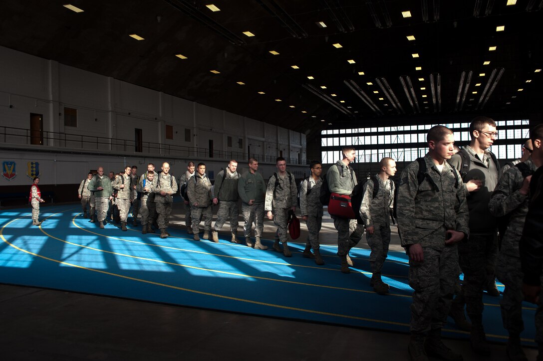 Ellsworth Airmen exit the Pride Hangar as they leave for Nellis Air Force Base, Nev. for Red Flag Jan. 20, 2012. Red Flag is a two-week combat exercise designed to train pilots from the U.S., North Atlantic Treaty Organization and other allied countries in planning and executing a wide-variety of combat missions. (U.S. Air Force photo by Airman Alystria Maurer/Released)