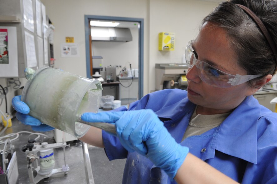 Senior Airman Heather Nowak, 2nd Dental Squadron lab technician, stirs stone mixture in the dental lab on Barksdale Air Force Base, La., Jan. 25. Stone mixture starts as a powder and turns into a clay like substance when mixed with water. Once mixed, technicians must work fast to set the mold before it dries.(U.S. Air Force photo/Airman 1st Class Micaiah Anthony)(RELEASED)