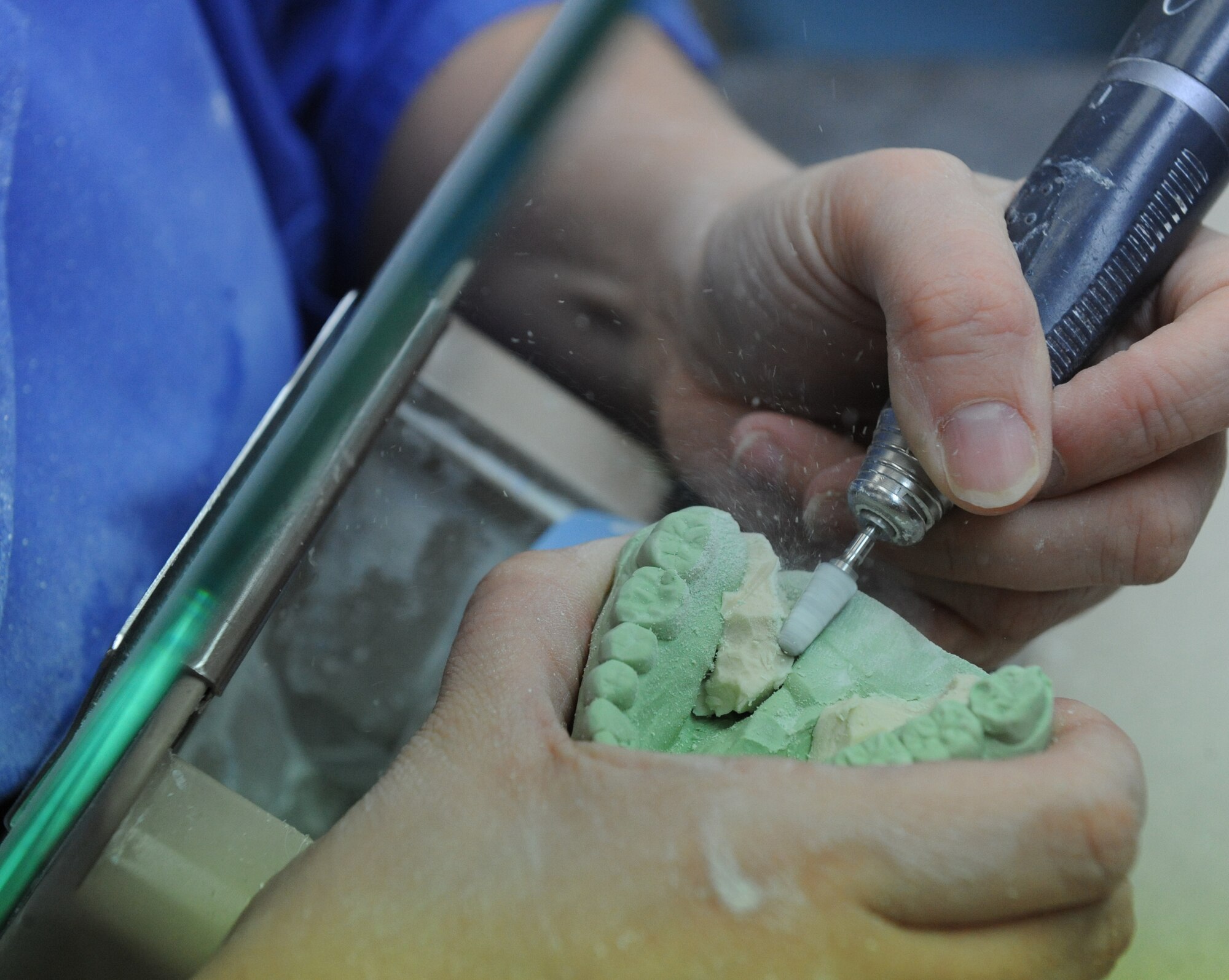 Senior Airman Heather Nowak, 2nd Dental Squadron lab technician, uses a hand piece to grind away excess stone in the dental lab on Barksdale Air Force Base, La., Jan. 25. Hand pieces are used to remove excess stone in hard to reach areas of a cast. (U.S. Air Force photo/Airman 1st Class Micaiah Anthony)(RELEASED) 
