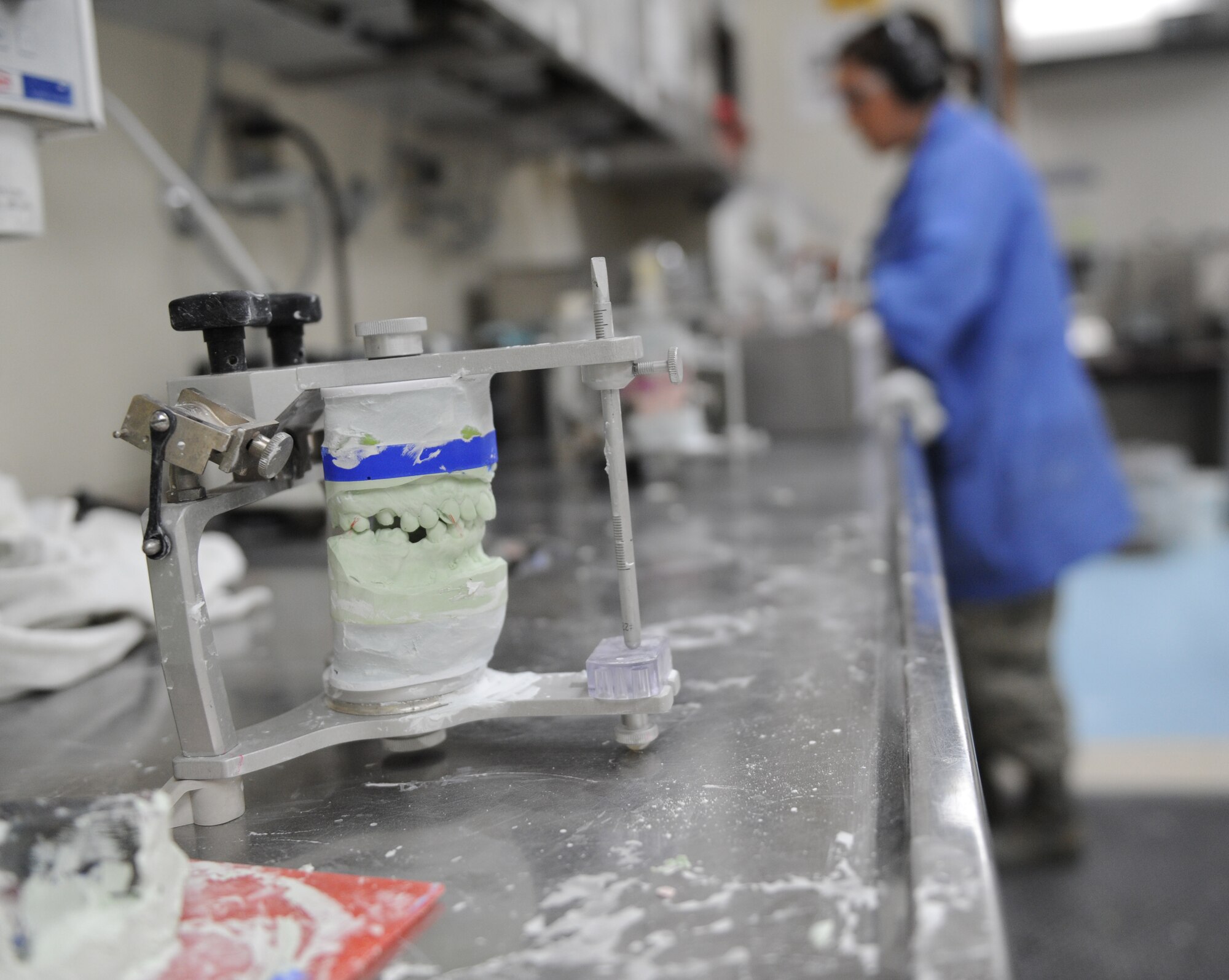 Senior Airman Heather Nowak, 2nd Dental Squadron lab technician, uses a cast trimmer to grind away excess stone in the dental lab on Barksdale Air Force, La., Jan. 25. Once a cast is complete, technicians can place both casts into an articulator to ensure they match. The articulator can be adjusted to simulate the natural movement of a jaw. (U.S. Air Force photo/Airman 1st Class Micaiah Anthony)(RELEASED) 