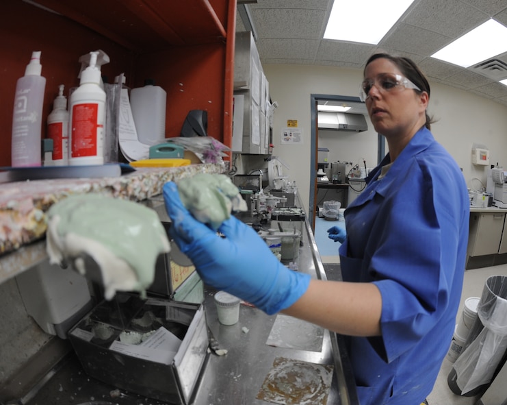 Senior Airman Heather Nowak, 2nd Dental Squadron lab technician, sets a cast with stone to dry in the dental lab on Barksdale Air Force Base, La., Jan. 25. In order to make a stone cast, patients must have a mold of their mouth made. Once the mold is created, it is taken to the dental lab to be cast.  (U.S. Air Force photo/Airman 1st Class Micaiah Anthony)(RELEASED) 