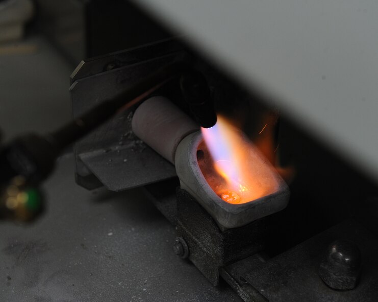 Master Sgt. Denny Shaffer, 2nd Dental Squadron, melts gold with a torch in the dental lab on Barksdale Air Force Base, La., Jan. 25. Gold crowns that do not fit the wearer are melted down for later use to save resources.(U.S. Air Force photo/Airman 1st Class Micaiah Anthony)(RELEASED) 