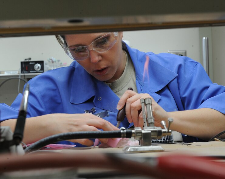 Senior Airman Heather Nowak, 2nd Dental Squadron lab technician, applies wax to a cast in the dental lab on Barksdale Air Force Base, La., Jan. 25. To apply wax to casts, lab technicians heat dental instruments with Bunsen burners. (U.S. Air Force photo/Airman 1st Class Micaiah Anthony)(RELEASED)