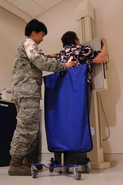 Senior Airman Alexi Langman (left), 9th Medical Group x-ray technician, performs a chest x-ray on Beth Oliver (right), 9th Medical Group x-ray technician, at the Diagnostic Imaging (X-Ray) center located inside the clinic at Beale Air Force Base, Calif., Jan. 25, 2012. Langman’s patients include deploying Airmen and those part of the flight crews. (U.S. Air Force photo by Airman 1st Class Stephanie Lovito/ Released)