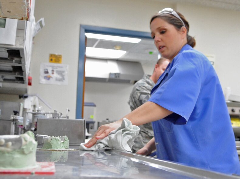 Senior Airman Heather Nowak, 2nd Dental Squadron lab technician, wipes a counter in the dental lab on Barksdale Air Force Base, La., Jan. 25. The dental lab makes implants, retainers, night and sports guards for military personnel. (U.S. Air Force photo/Airman 1st Class Micaiah Anthony)(RELEASED) 