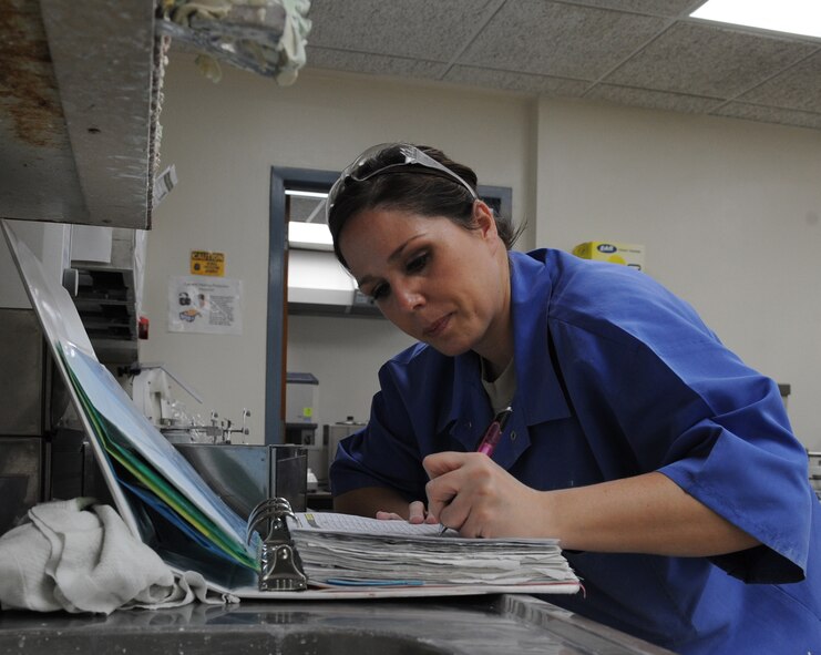 Senior Airman Heather Nowak, 2nd Dental Squadron lab technician, writes in a case log in the dental lab on Barksale Air Force Base, La., Jan. 25. Case logs are used to track work and document the patients' prescriptions. (U.S. Air Force photo/Airman 1st Class Micaiah Anthony)(RELEASED) 