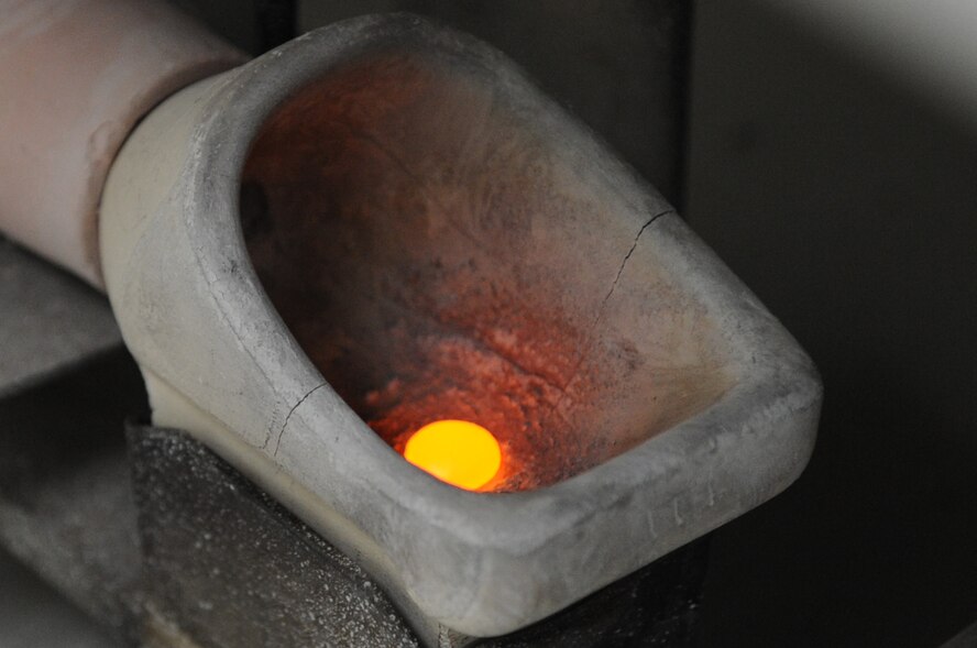 Melted gold glows after being heated by a blow torch in the dental lab on Barksdale Air Force Base, La., Jan. 25. In order for gold to melt it must be heated to 1,947 degrees Fahrenheit.(U.S. Air Force photo/Airman 1st Class Micaiah Anthony)(RELEASED)  