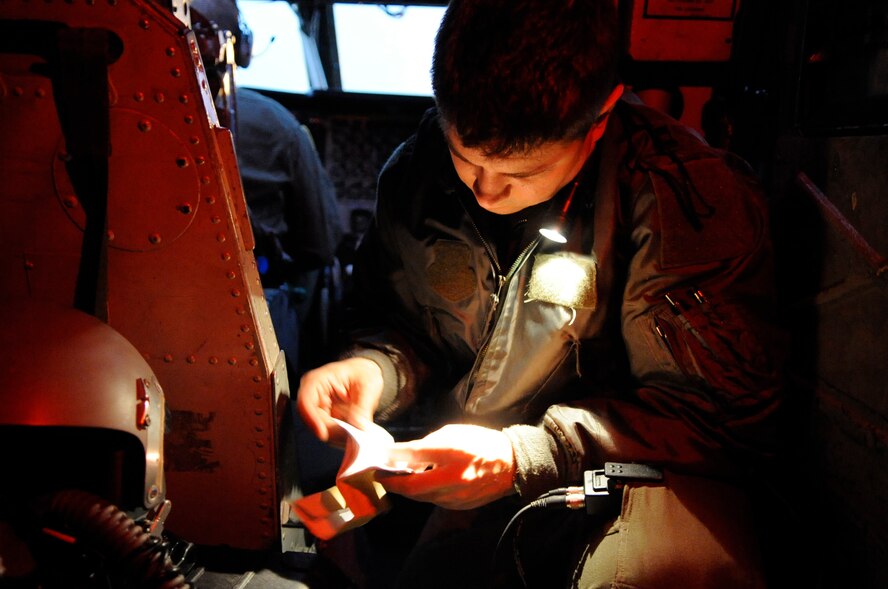 Capt. Kristopher Rorberg, 2nd Operations Support Squadron instructor pilot, looks through a notebook prior to his flight's departure on Barksdale Air Force Base, La., Jan. 25. Rorberg sits behind the pilot to provide guidance whenever needed. (U.S. Air Force photo/Airman 1st Class Andrea F. Liechti)(RELEASED)