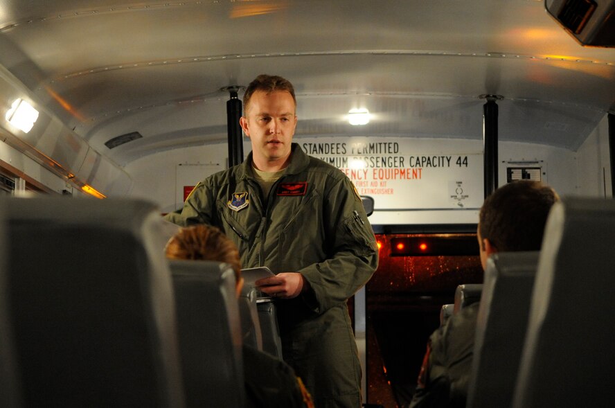 A B-52H Stratofortress pilot discusses flight plans with his team on the flightline at Barksdale Air Force Base, La., Jan. 25. The B-52 air crew members ride together on a bus from the 2nd Operations Support Squadron to their jet. This provides them with time to discuss any important mission-related details prior to their departure. (U.S. Air Force photo/Airman 1st Class Andrea F. Liechti)(RELEASED)