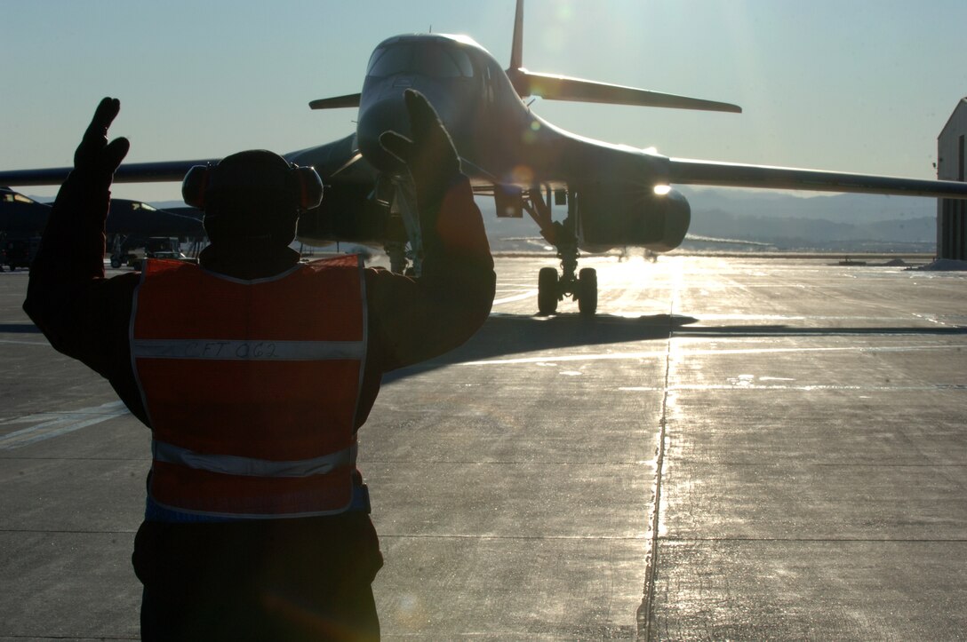 Scott Harrington, 28th Aircraft Maintenance Squadron civilian contractor, marshals a B-1B returning from a forward operating location in Southwest Asia at Ellsworth Air Force Base, S.D., Jan. 17, 2012. Ellsworth aircrews provided critical air presence, precision strike, and surveillance and reconnaissance capabilities to support military objectives in the region. (U.S. Air Force photo by Airman 1st Class Zachary Hada/Released)