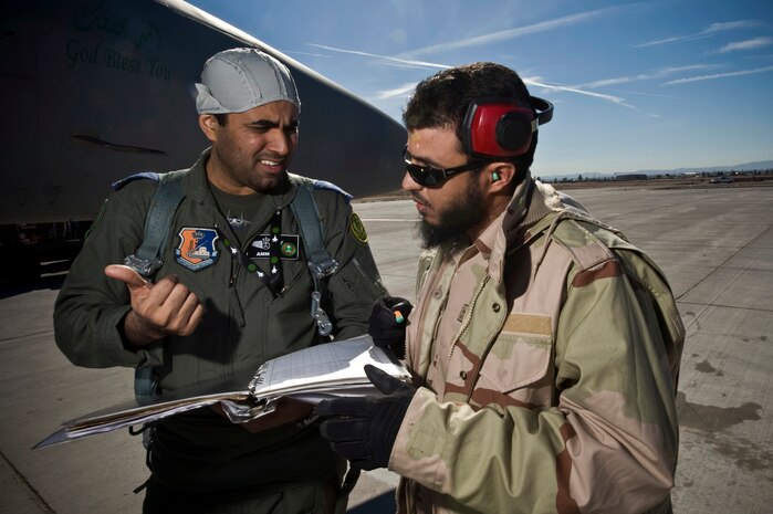 Royal Saudi Air Force Col. Ammar, RSAF Red Flag commander, discusses a pre-flight check list with Staff Sgt. Obaidallah, RSAF crew chief, before a training mission during Red Flag 12-2 Jan. 25, 2012, at Nellis Air Force Base, Nev. Red Flag is a realistic combat training exercise involving the air forces of the United States and its allies. The exercise is hosted north of Las Vegas on the Nevada Test and Training Range. (U.S. Air Force photo by Senior Airman Brett Clashman)
