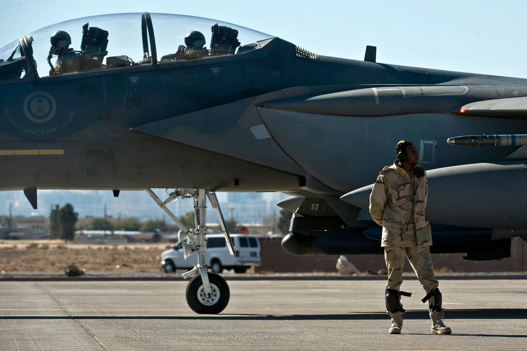 Royal Saudi Air Force Staff Sgt. Hassan, crew chief, waits to marshal an F-15 Strike Eagle before a training mission during Red Flag 12-2 Jan. 25, 2012, at Nellis Air Force Base, Nev. Red Flag is a realistic combat training exercise involving the air forces of the United States and its allies. The exercise is hosted north of Las Vegas on the Nevada Test and Training Range. (U.S. Air Force photo by Senior Airman Brett Clashman)