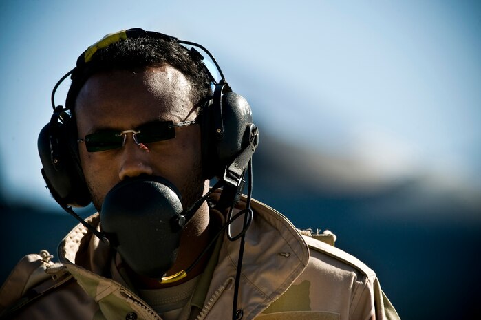 Royal Saudi Air Force Staff Sgt. Hassan, crew chief, communicates via headset with pilots before a training mission during Red Flag 12-2 Jan. 25, 2012, at Nellis Air Force Base, Nev. Red Flag is a realistic combat training exercise involving the air forces of the United States and its allies. The exercise is hosted north of Las Vegas on the Nevada Test and Training Range. (U.S. Air Force photo by Senior Airman Brett Clashman)