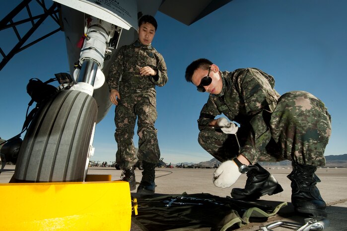 Republic of Korea Tech. Sgt. Lee Jae-Moo and Senior Master Sgt. Kim Seok, conduct pre-launch maintenance for an F-15E Strike Eagle during Red Flag 12-2 Jan. 24, 2012, at Nellis Air Force Base, Nev. Red Flag is a realistic combat training exercise involving the air forces of the United States and its allies. The exercise is hosted north of Las Vegas on the Nevada Test and Training Range.(U.S. Air Force photo by Staff Sgt. Christopher Hubenthal) 
