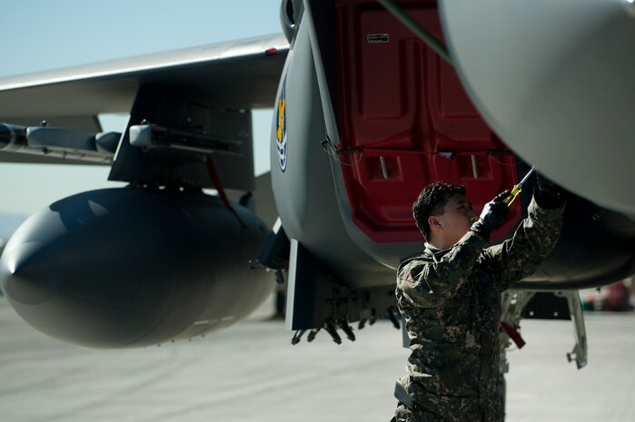 Republic of Korea Air Force Senior Master Sgt. Kim Seok, conducts pre-launch maintenance for an F-15E Strike Eagle during Red Flag 12-2 Jan. 24, 2012, at Nellis Air Force Base, Nev. Red Flag is a realistic combat training exercise involving the air forces of the United States and its allies. The exercise is hosted north of Las Vegas on the Nevada Test and Training Range. (U.S. Air Force photo by Staff Sgt. Christopher Hubenthal)