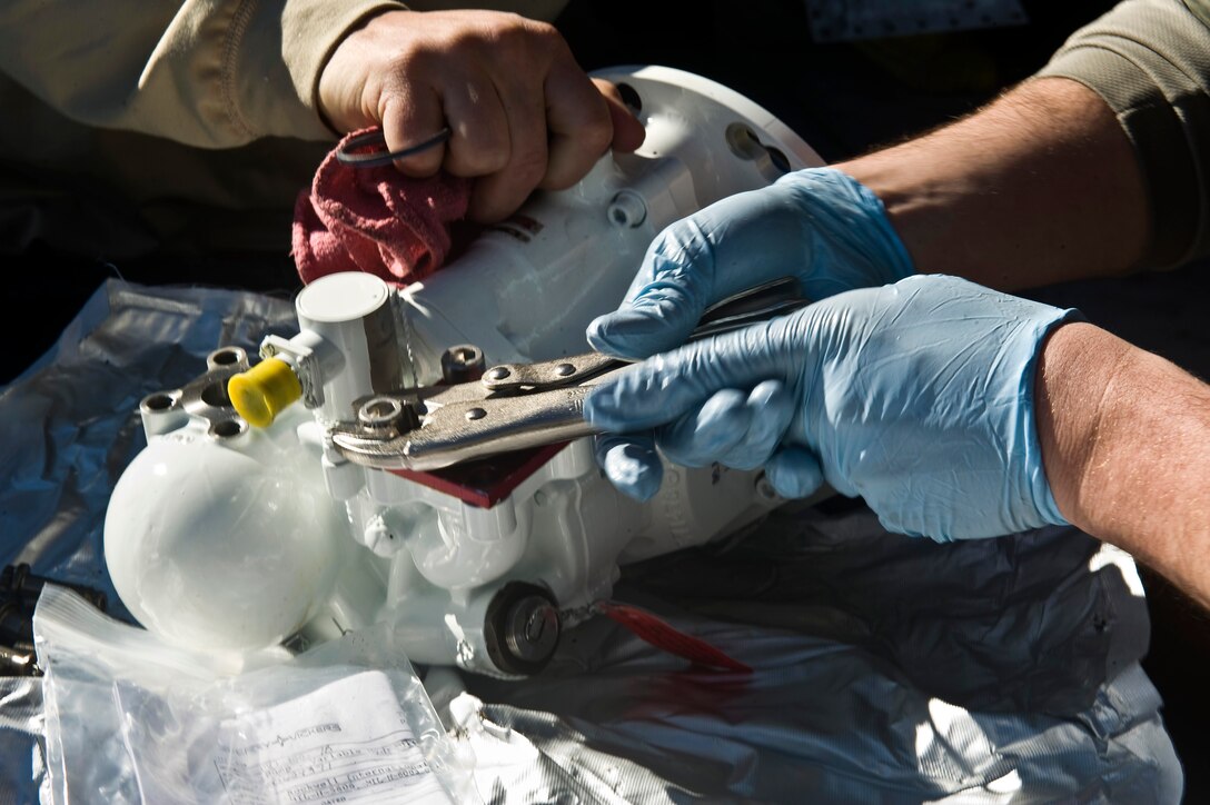 U.S. Air Force Airman 1st Class Brandon Wood, 28th Aircraft Maintenance Squadron aerospace propulsion apprentice, Ellsworth Air Force Base, S.D., tightens lug nuts on a hydraulic pump during Red Flag 12-2 Jan. 24, 2012, at Nellis Air Force Base, Nev. Red Flag is a realistic combat training exercise involving the air forces of the United States and its allies. The exercise is hosted north of Las Vegas on the Nevada Test and Training Range. (U.S. Air Force photo by Senior Airman Brett Clashman)
