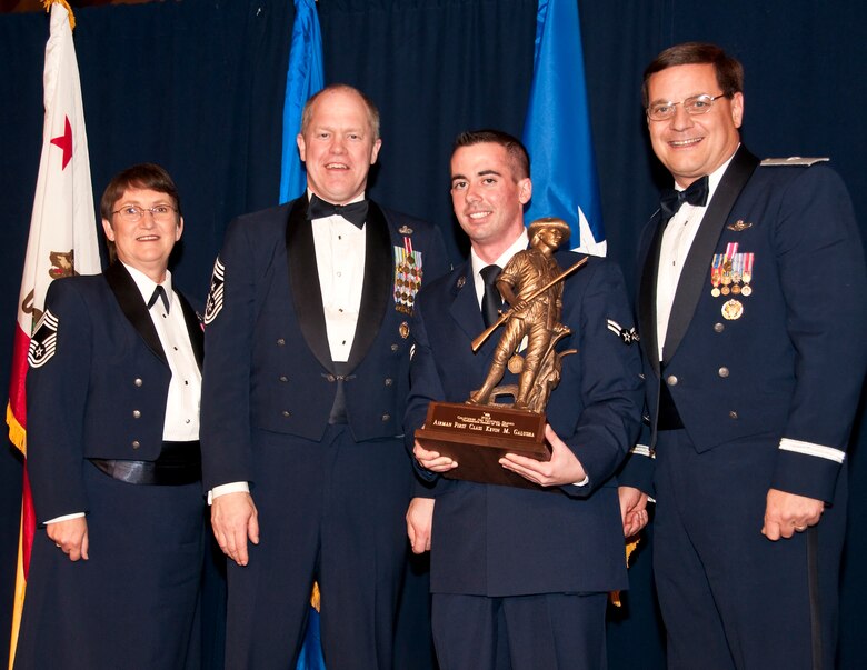 Airman 1st Class Kevin M. Galusha (center) from the 162nd Combat Communications Group accepts the Outstanding Airman of the Year award in the Airman category. Accompanied by Chief Master Sgt. Debra Fordyce, (far left) Command Chief Master Sgt. Christopher Muncy, (left) and Brig. Gen. James Witham at the annual Outstanding Airman Of The Year Awards Banquet at The Sheraton Universal Hotel, Universal City, Calif., January 21, 2012. Each organization nominated four candidates for Airman of The Year, NCO of The Year, Sr. NCO of The Year and First Sergeant of The Year. U.S. Air Force photo by Tech. Sgt. Alex Koenig
