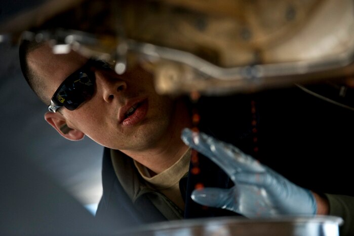 U.S. Air Force Staff Sgt. Jonathon Hill, 28th Aircraft Maintenance Squadron aerospace propulsion journeyman, Ellsworth Air Force Base, S.D., tries to cease a hydraulic pump underneath a B-1B Lancer during Red Flag 12-2 Jan. 24, 2012, at Nellis AFB, Nev. Red Flag is a realistic combat training exercise involving the air forces of the United States and its allies. The exercise is hosted north of Las Vegas on the Nevada Test and Training Range. (U.S. Air Force photo by Senior Airman Brett Clashman)