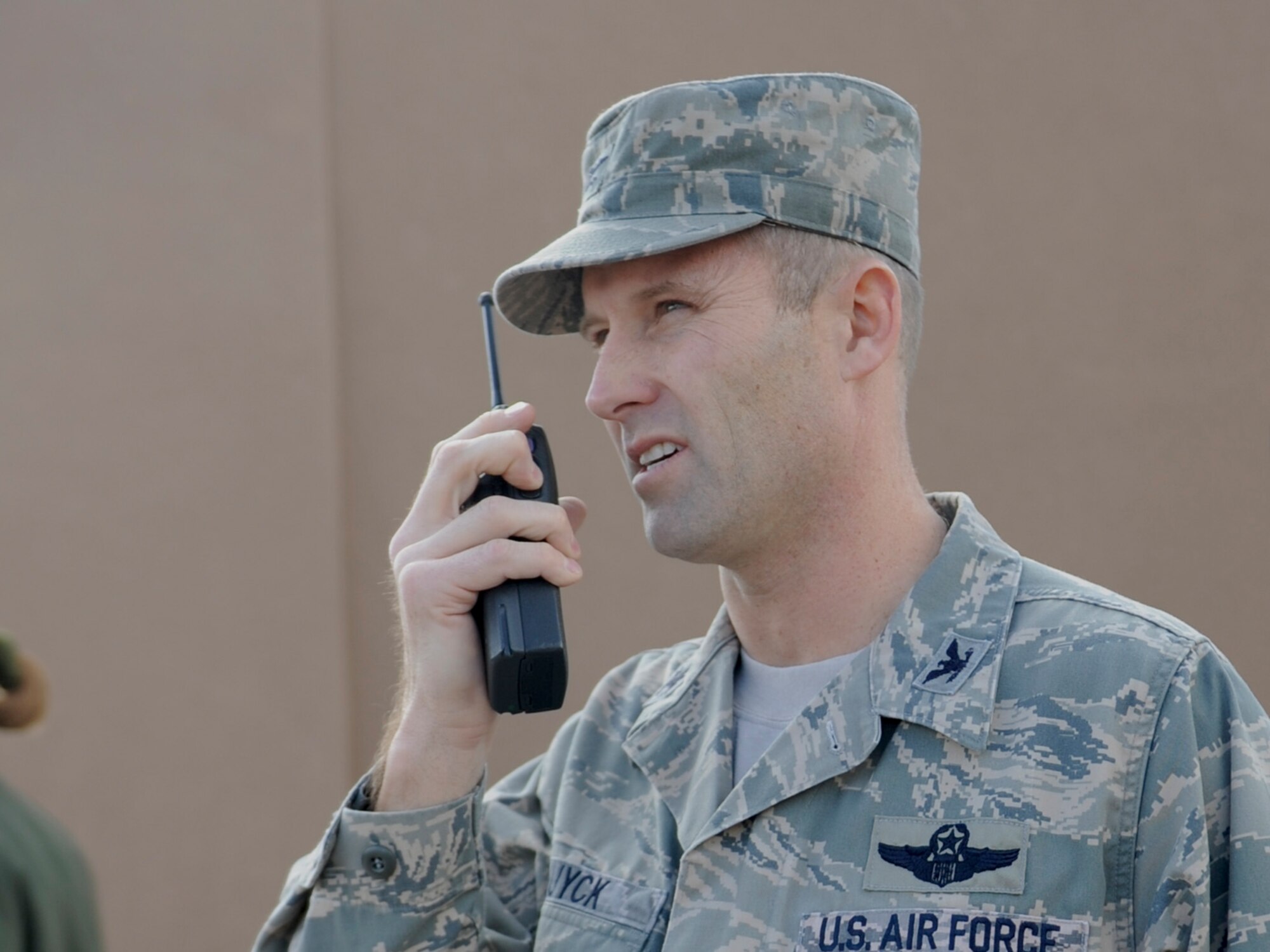 HOLLOMAN AIR FORCE BASE, N.M. -- U.S. Air Force Col. Kevin Huyck, 49th Wing vice commander, radios the pilot of an Air Force search and rescue helicopter that found and was transporting a search subject to White Sands Nation Monument Headquarters Jan. 16, for evaluation and reuniting with his family. Huyck was leading the search effort that helped coordinate more than 70 Air Force personnel in the massive, multi-agency search for the lost 15 year old boy who suffers from autism. (U.S. Air Force Photo by Tom Fuller/ Released)