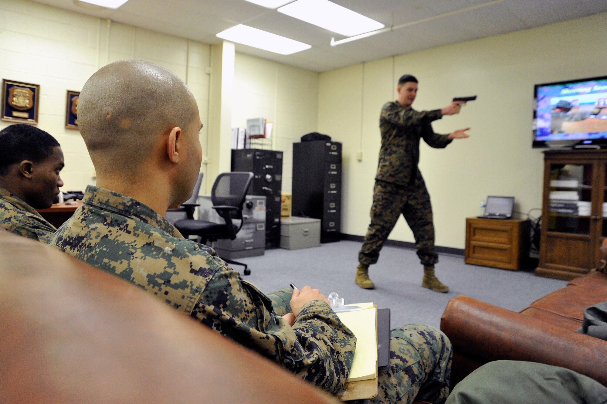 Marine Sergeant Daniel Bason, Marine Transport Squadron Andrews operations chief, teaches Lance Corporals Samael J. FanesteEspina, and Jean Baptiste Henry, Marine Transport Squadron Andrews operations technicians, Beretta M9 firing positions during their Lance Corporal’s Course here, Jan. 10. The Marines, along with the rest of the services, recently replaced their use of the .45 pistol with the Beretta M9. (U.S. Air Force Photo/Senior Airman Perry Aston) 