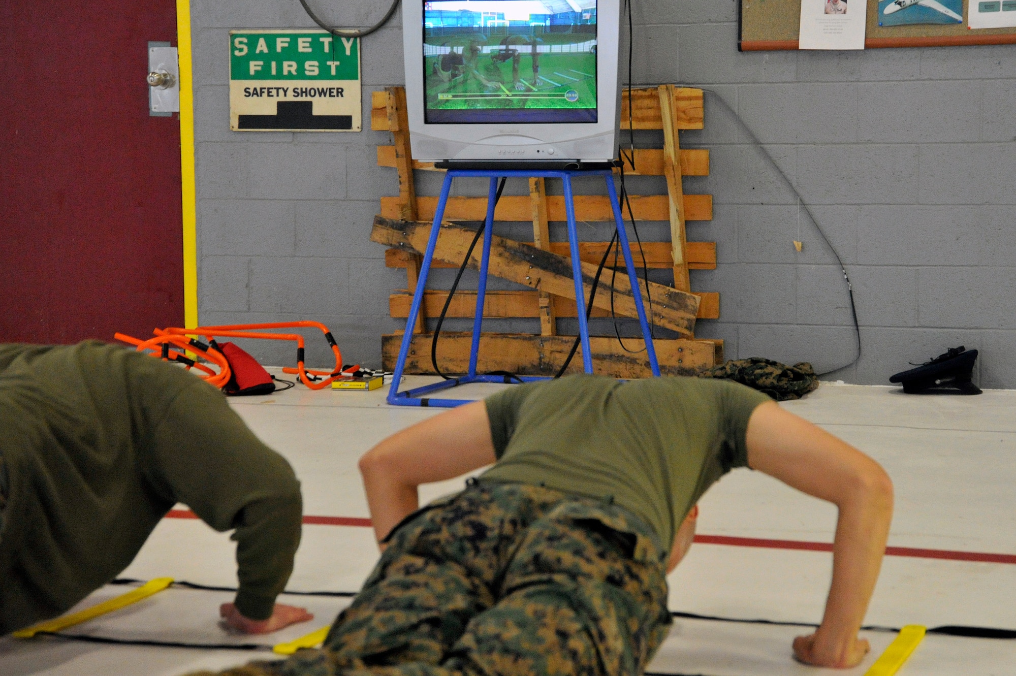 Marine Lance Corporals Samael J. FanesteEspina and Jean Baptiste Henry, Marine Transport Squadron Andrews operations technicians, perform physical training during their Lance Corporal’s Course here, Jan. 10. The course provides training in drill, Marine Corps history, codes of conduct, mentorship and many other classes geared toward improving the Marines before they take on the responsibility of becoming NCOs. (U.S. Air Force Photo/Senior Airman Perry Aston)