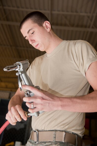 U.S. Air Force Senior Airmen Jacob Hensley, 820th Combat Operations Squadron security forces, puts together an air compressor to build lockers at Moody Air Force Base, Ga., Jan. 24, 2012. Warehouse lockers at the 820th COS house assets for Airmen who get tasked for short-notice deployments. (U.S. Air Force Photo by Airmen 1st Class Paul Francis/Released)
