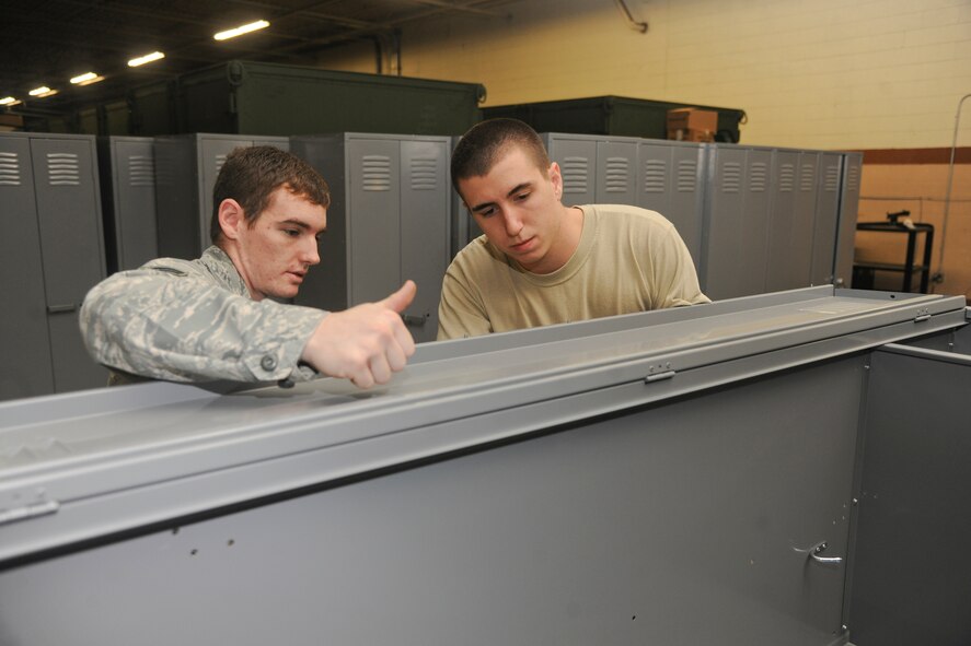 U.S. Air Force Senior Airmen Edward Young, 820th Combat Operations Squadron security forces, right, reviews a locker assembly with Senior Airmen Jacob Hensley, 820th COS security forces, at Moody Air Force Base Ga., Jan. 24, 2012. Putting together lockers for storage is just a part of the 820th COS’s job; they also house and supply equipment for deploying personnel, and recently received the 2011 Air Combat Command Logistics Readiness Squadron of the Year award in the non-flying unit category. (U.S. Air Force Photo by Airmen 1st Class Paul Francis/Released)